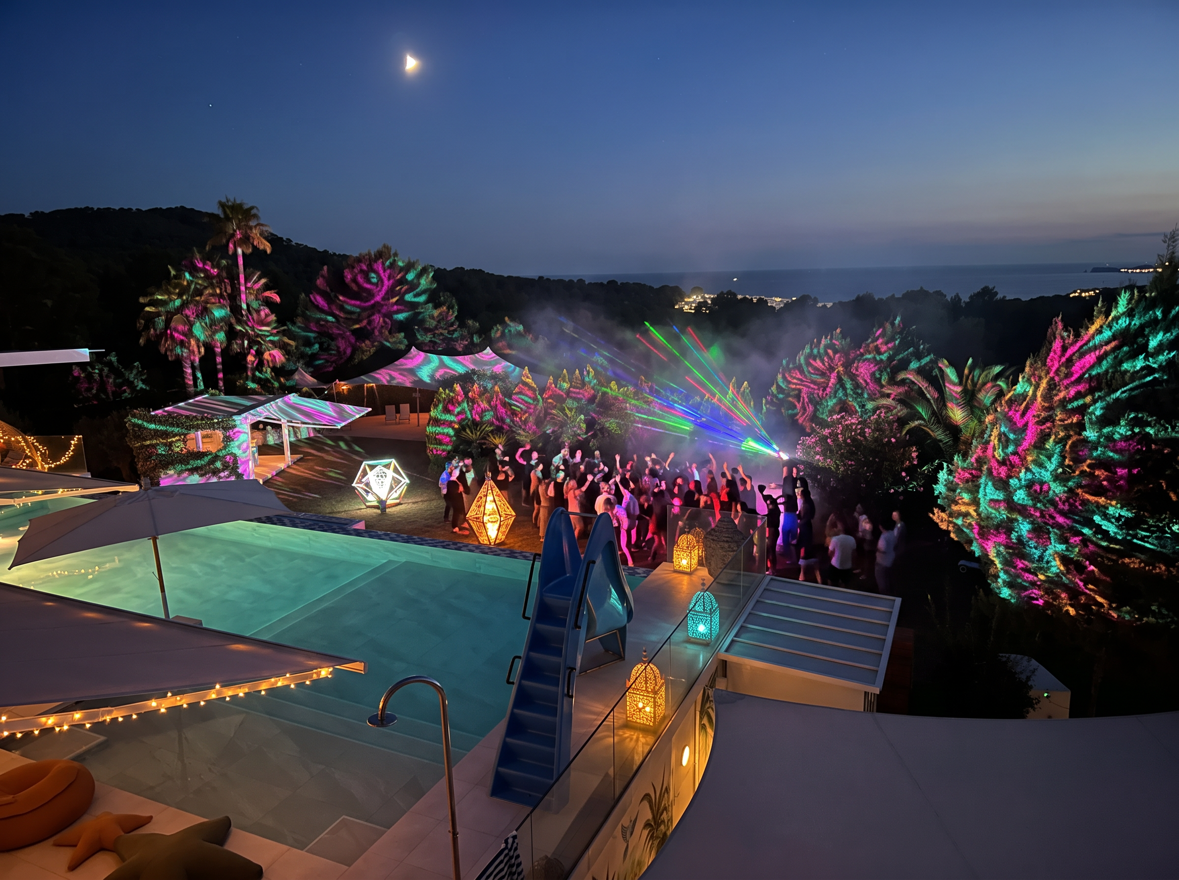 Guests dancing in the garden under large projections
